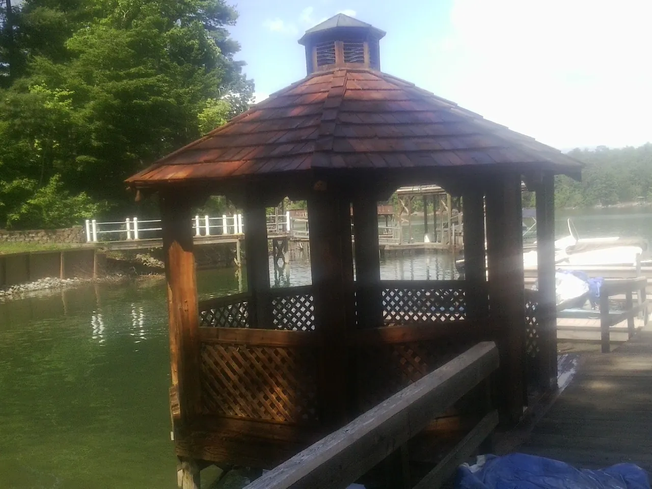 Cedar shake gazebo roof rebuilt on a lake dock in Johnson